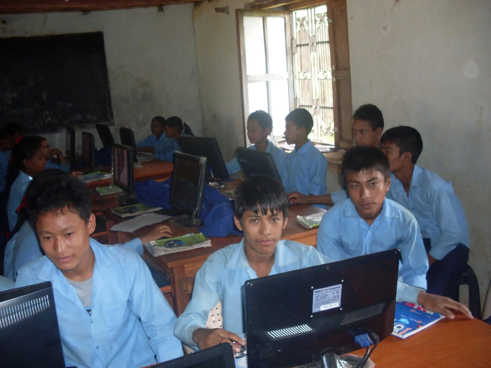 Students learning in a computer lab supported by Aashirbad Foundation